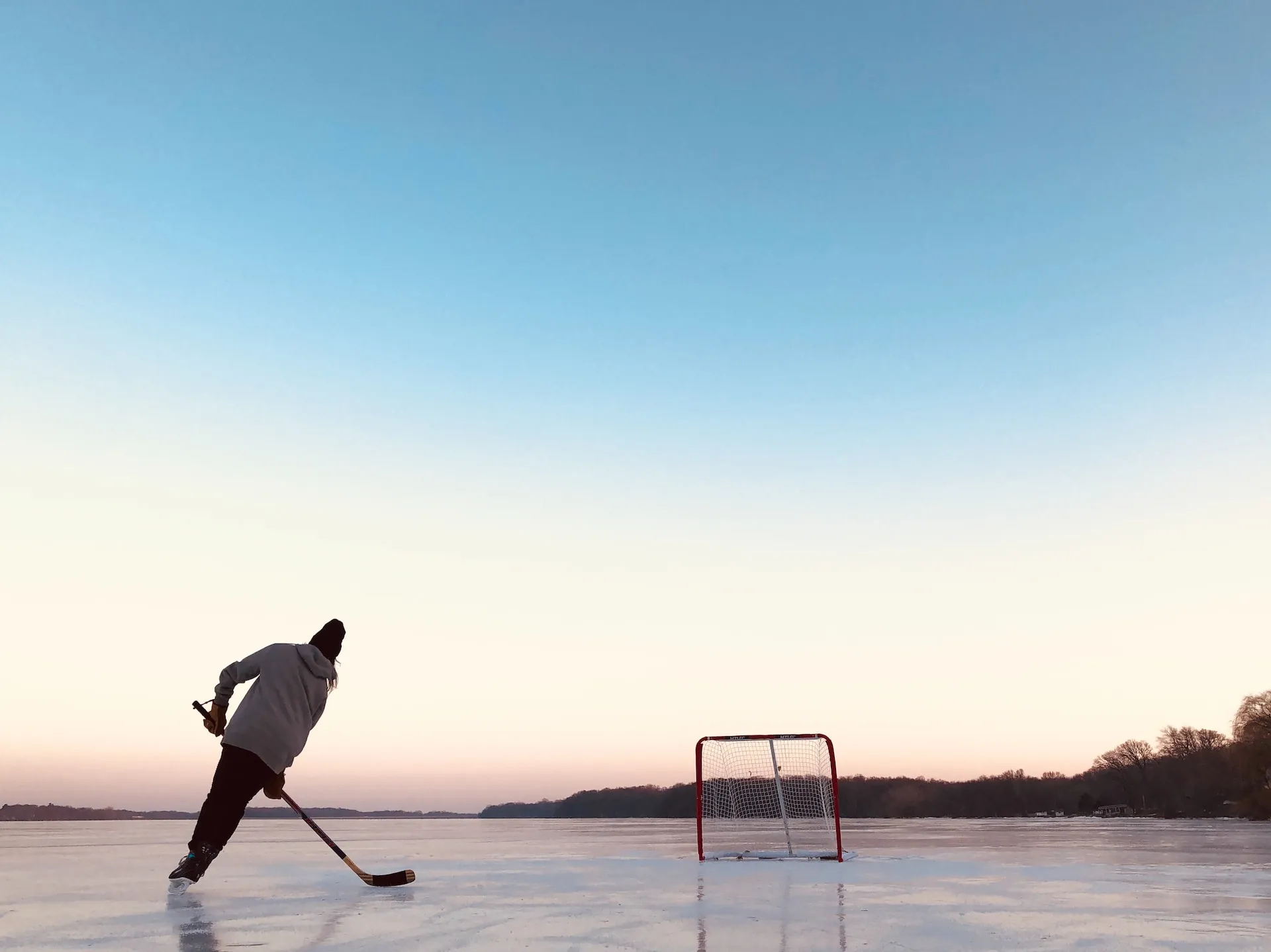 a man playing pond hockey